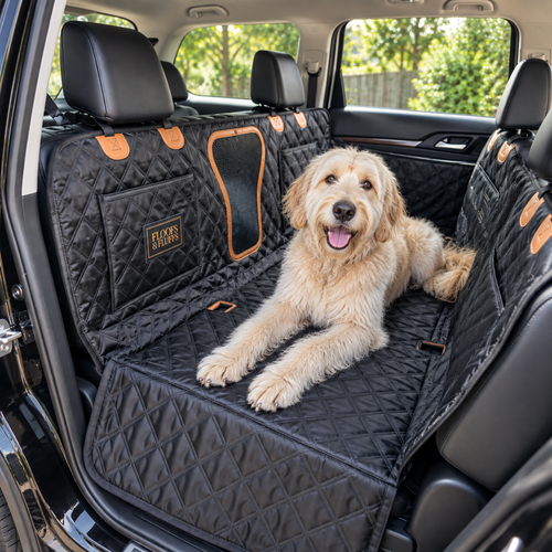 Happy dog in a quilted black SUV seat hammock